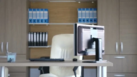 Empty office with a personal computer on the table and folders on the back. No Stock Footage 82912797