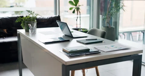 Empty office, table and laptop with documents, graphs and interior design for Stock Footage 319939096
