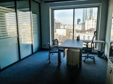Empty office with a table and three chairs with a panoramic view of the city  Stock Photos