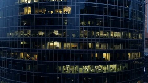 Empty office windows of skyscrapers at late evening. 4K. Stock Footage 77729541