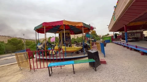 Empty old carousel spinning outdoors Video stock 210539480