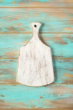 Empty old cutting board on a cyan background Fotos de archivo