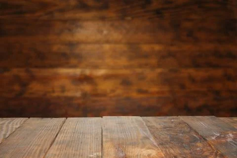 Empty old Dark wooden rustic table top made of planks with uneven edges on gr 스톡 사진