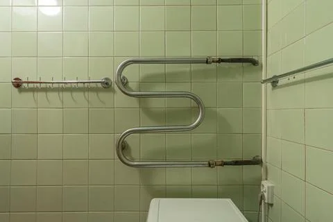 Empty old drying pipe and hanger in the bathroom Stock Photos