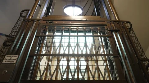 Empty old elevator descending and passing by at the floor of a building Stock Footage 156224417