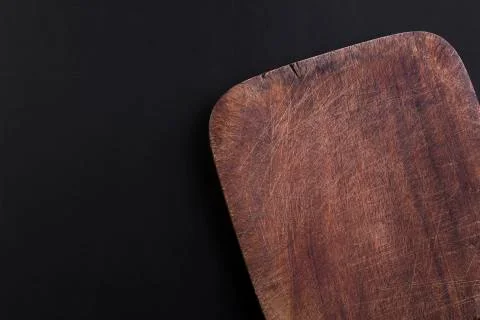 Empty old oak cutting board on a black background Stock Photos