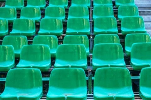 Empty old plastic chairs in the stands of the summer theater. Many empty seat Stock Photos