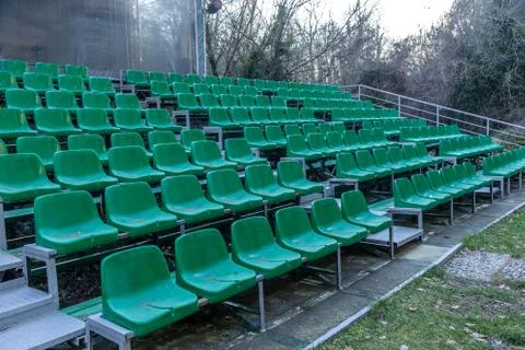 Empty old plastic chairs in the stands of the summer theater. Many empty seat Stock Photos