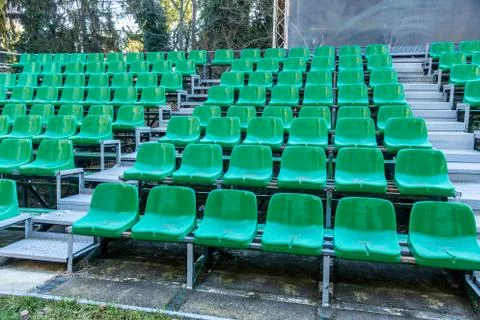 Empty old plastic chairs in the stands of the summer theater. Many empty seat Stock Photos