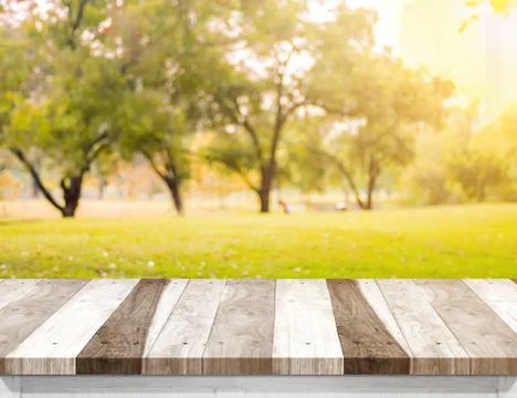Empty old rustic wood plank table top with blur forest tree with sunlight,Aut Stock Photos