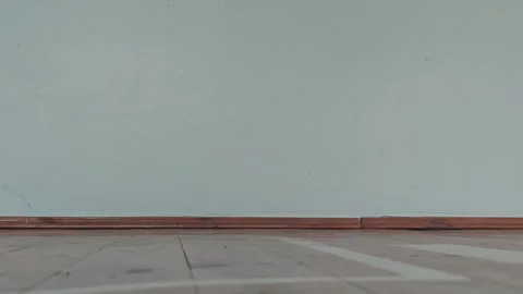 Empty old school gymnasium interior with a worn wooden floor, white court Stock Footage 345971332