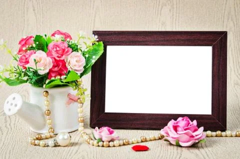 Empty old wooden photho frame with roses. Stock Photos