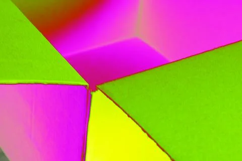 Empty open cardboard box, changed colors, bright background in pastel colors. Stock Photos