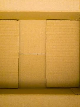 Empty open cardboard box viewed from above with flaps visible Stock Photos