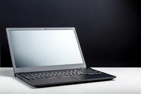 Empty open laptop with mockup on white desk table with black screen. minimali Stock Photos