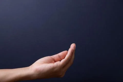 Empty open man hand on black background. Stock Photos
