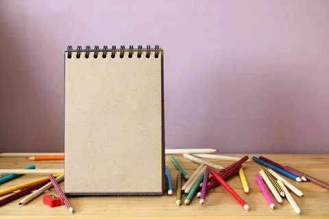 An empty open notebook made of brown paper and colored pencils. education, sc Stock Photos
