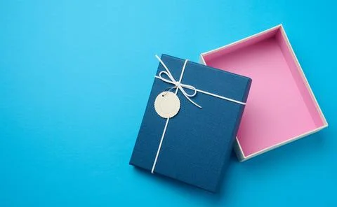 Empty open rectangular gift cardboard box on blue background, top view Stock Photos