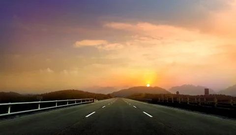 Empty open road during sunset Stock Photos