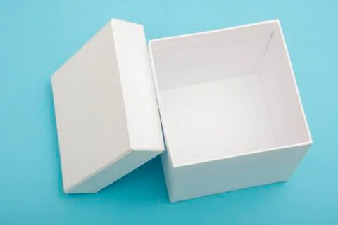 Empty, open white gift box on blue background with copy space 库存照片