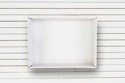 Empty opened cardboard box on white wooden texture Stock Photos