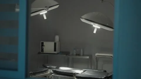 Empty operating room and operating room lamps with lights on Stock Footage 246910366