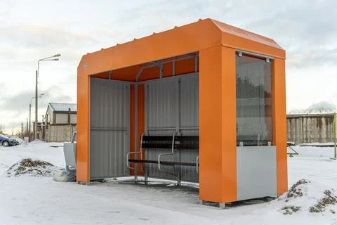 An empty orange bus stop in winter Foto stock