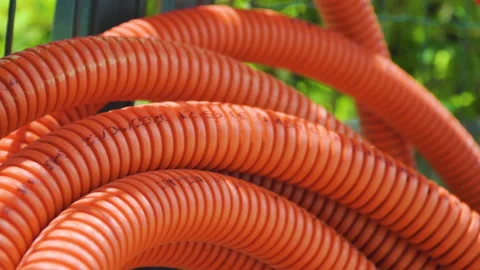 Empty orange cable protection pipe tube for fiber optic cable, close up pan shot Stock Footage 133613952