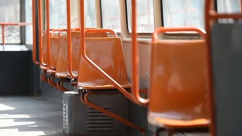 Empty orange chairs in an empty public tram during coronavirus pandemic 스톡 동영상 127290967