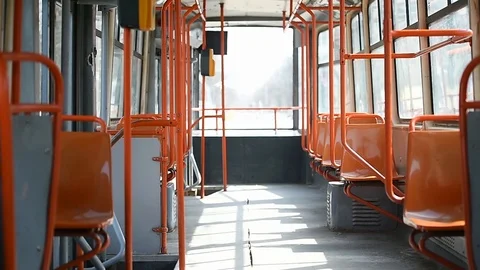 Empty orange chairs in an empty public tram during coronavirus pandemic 스톡 동영상 127291138