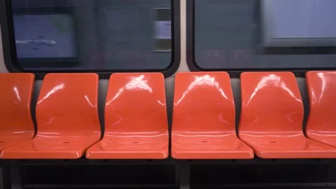Empty orange seats interior of a subway at the station during quarantine Stock Footage 144485205