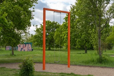 Empty orange swing in green park Stock Photos