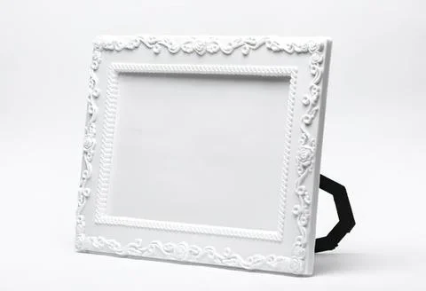 Empty ornate white picture frame on a white background 스톡 사진