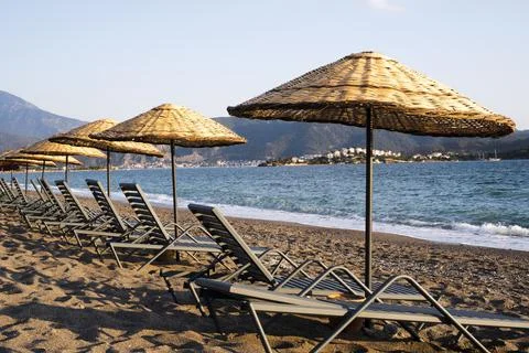 Empty otantic beach umbrellas empty beach in summer day Foto stock