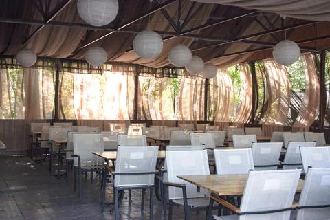 Empty outdoor cafe in the park. Without people. Summer, sunny day Stock Photos