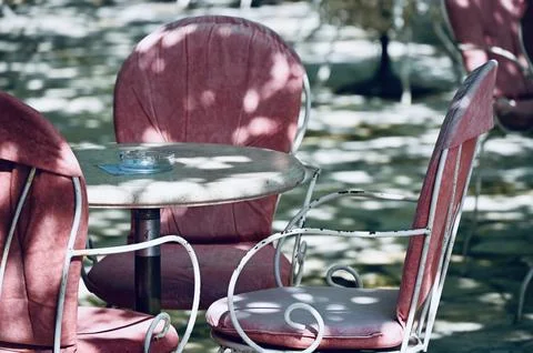 Empty Outdoor Cafe Table with Pink Chairs Stock Photos