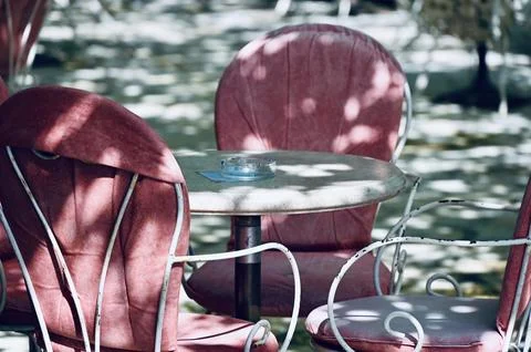 Empty Outdoor Cafe Table with Pink Chairs Stock Photos
