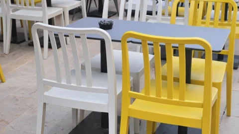 Empty outdoor cafe tables and chairs waiting for customers on sunny day foo.. Stock Footage 332914937