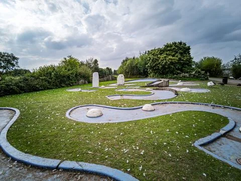 Empty outdoor mini golf course in a park during cloudy day Stock Photos