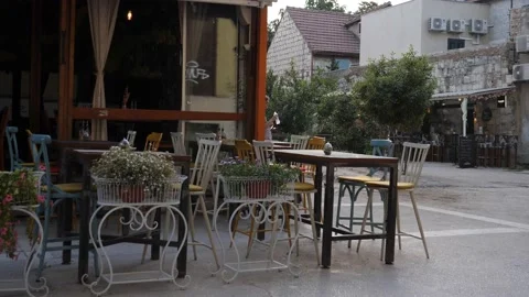Empty Outdoor Seating in a Corner Cafe at Evening, Pan Stock Footage 204014241