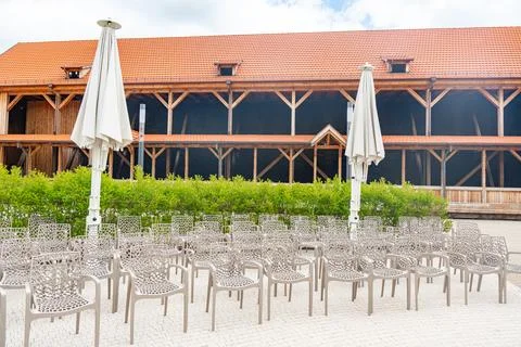 Empty Outdoor Seating in Front of Rustic Wooden Barn Stock Photos