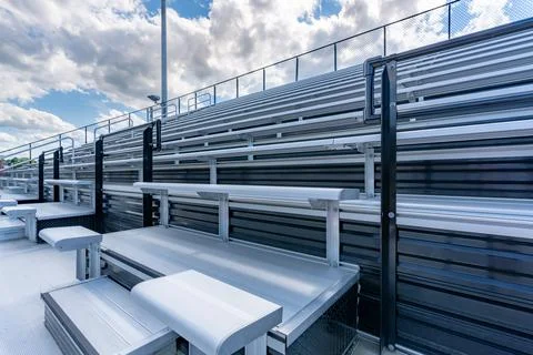Empty outdoor stadium accessible bleacher seats with companion seats. Fotos de archivo