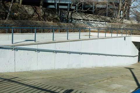 Empty outdoor swimming pool with steps and railings Stock Photos