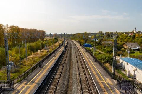 Empty outdoor train station platform at sunday morning Stock Photos