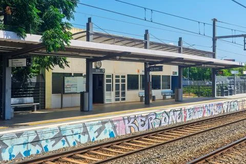 Empty outdoor train station platform with a covered shelter Stock Photos