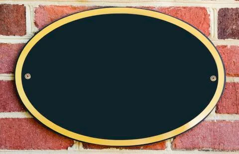 Empty oval plaque attached to brick wall Stock-Fotos