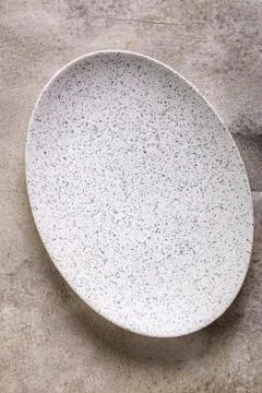 Empty oval plate on stone Fotos de archivo