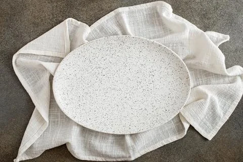 Empty oval plate on tablecloth Stock Photos