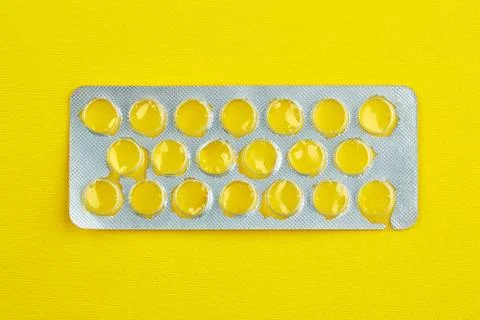 Empty package of tablets on yellow background Stock Photos