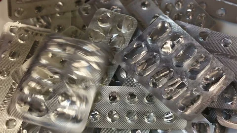 Empty packages of pills, capsules, lozenges fall into a pile. Real time, average Stock Footage 145586804